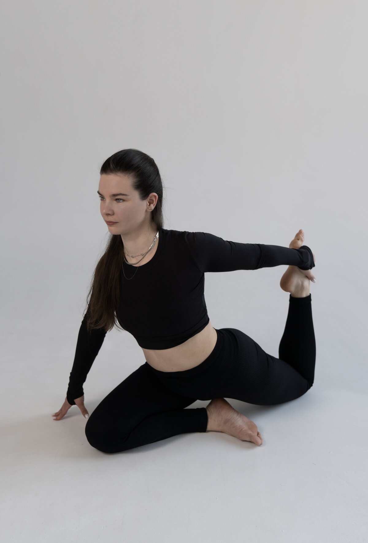Olena Hilova demonstrating a seated hip and lower-back mobility stretch