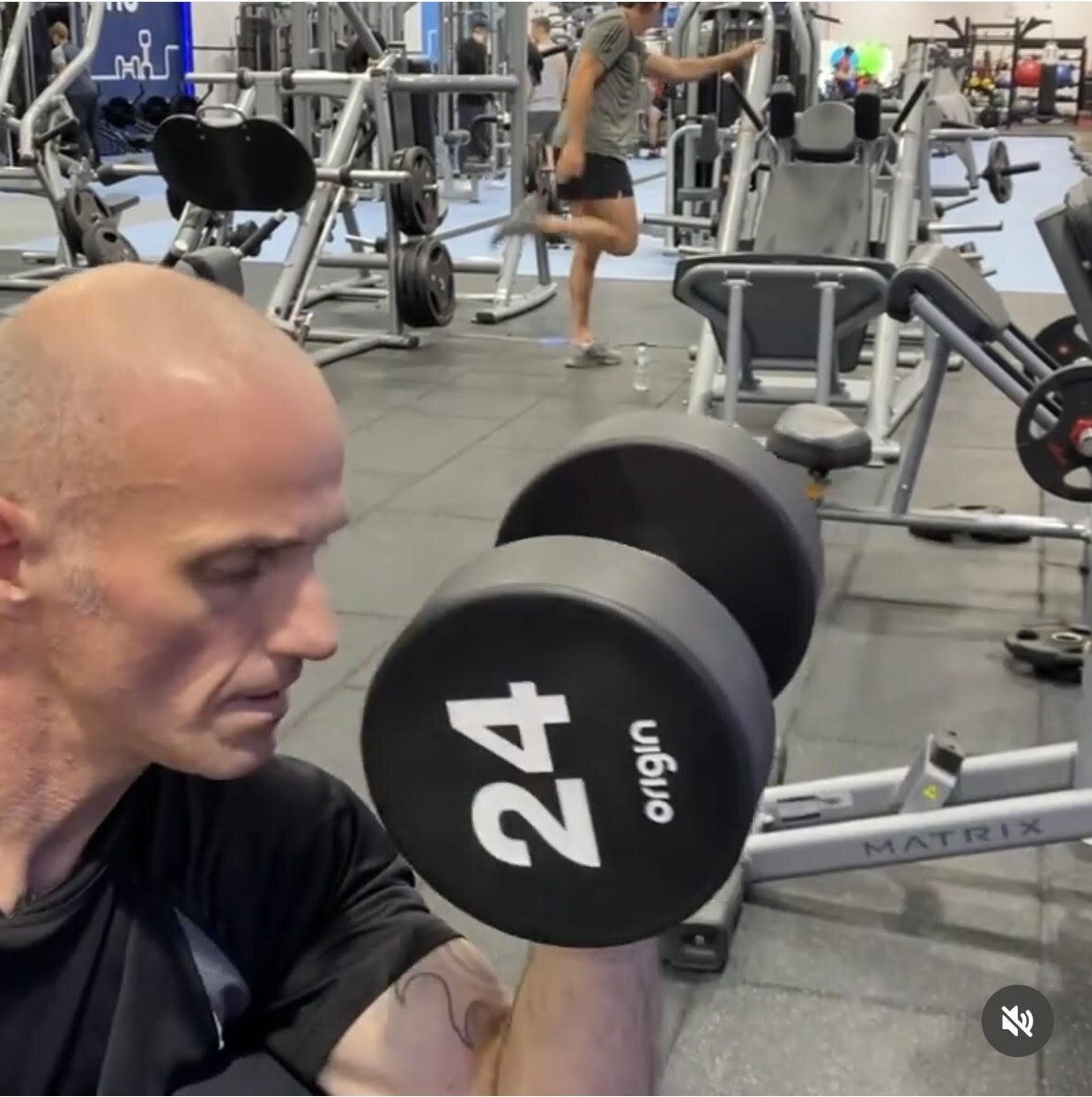 Matt Anderson performing a 24kg dumbbell curl in a commercial gym