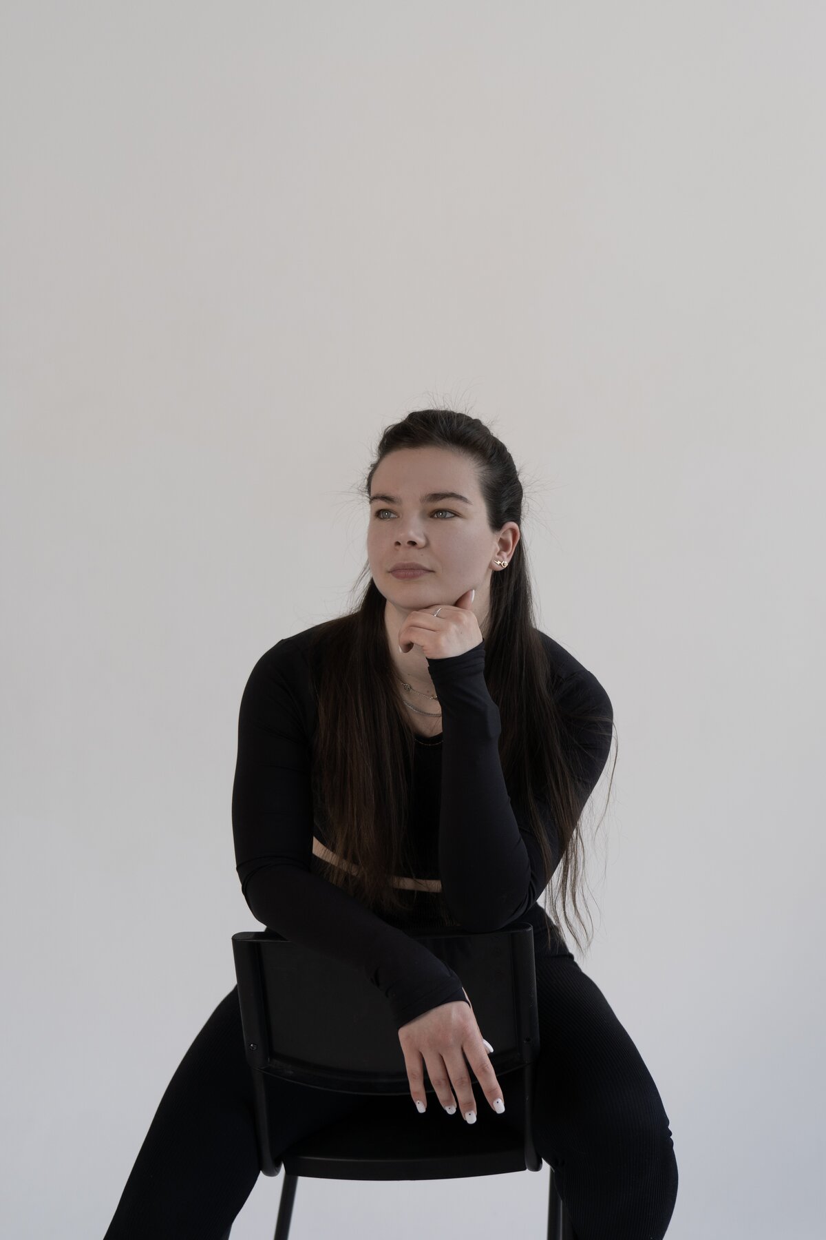 Olena Hilova, physiotherapist and online personal trainer, seated studio portrait