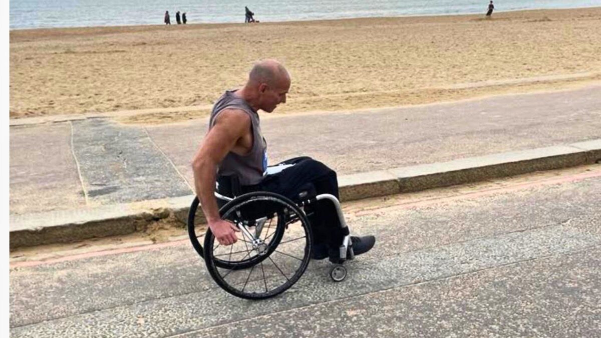 Matt Anderson in his wheelchair training along a seafront promenade