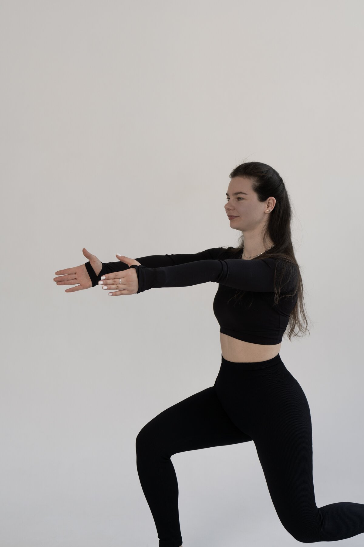 Olena Hilova demonstrating a forward lunge with the arms extended