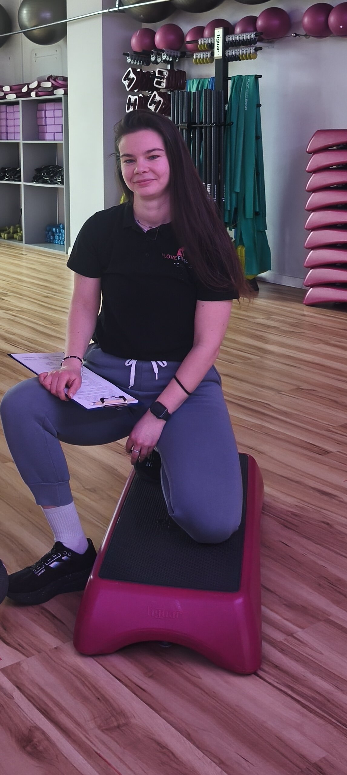 Olena Hilova reviewing assessment notes before a physiotherapy-led personal training session
